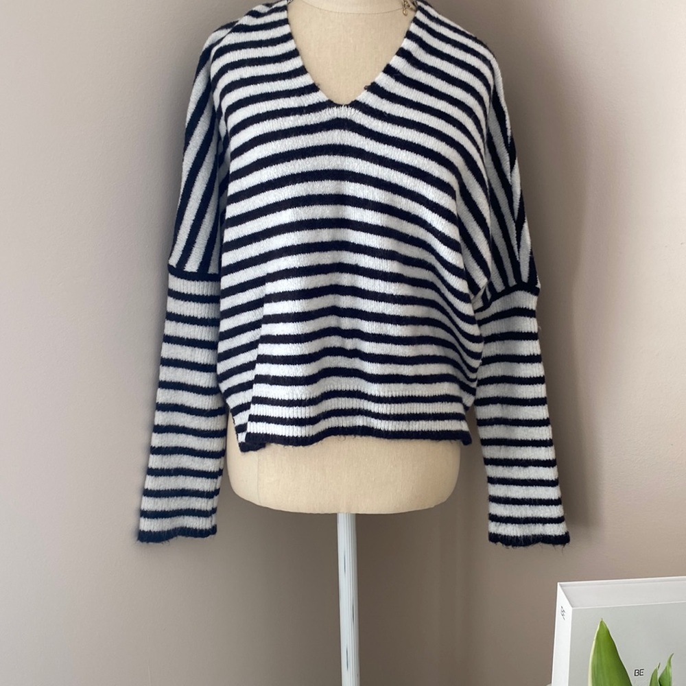 Beautiful light weight sweater with fitted half sleeve and cross cross tied back